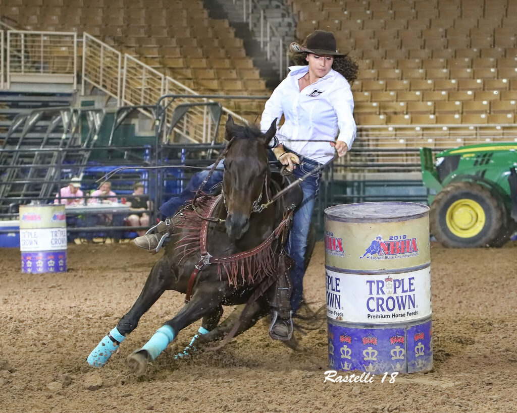 Holly and Benelli competing in the National Barrel Horse Association Finals in 2018. 